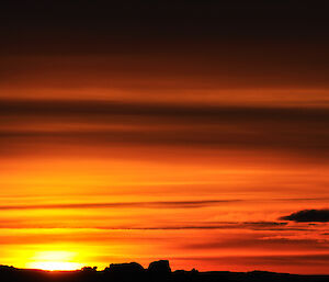 Anzac Day sunset showing rich colours as the sun dips.