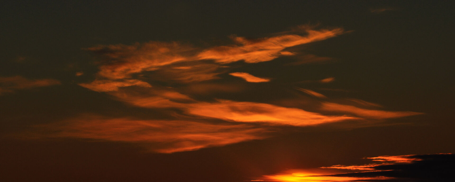 Sunset at Mawson, with deep red colours reflected on the clouds