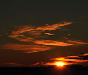 Sunset at Mawson, with deep red colours reflected on the clouds