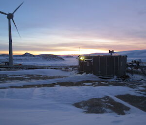 Silver hydroponics hut in foreground with sun rise in background