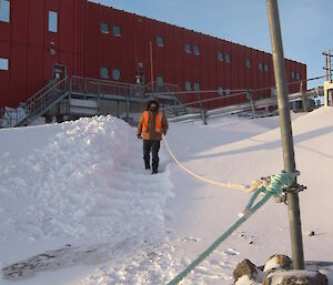 Staircase cut into bank of snow with line for a handhold beside