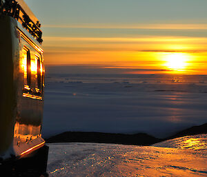 Beautiful colours of sunset reflecting off sea ice, plateau ice and Hägglunds at the same time