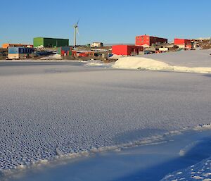 View of Mawson station with sea ice in the foreground.