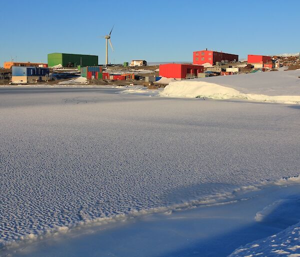 View of Mawson station with sea ice in the foreground.