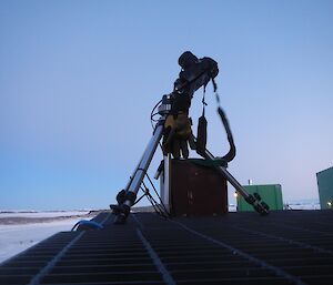 Camera on tripod with glove for holding timer and large battery underneath