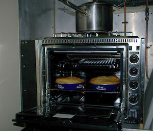 Two tinned pies cooked to perfection with beautiful puff pastry tops in the new stove