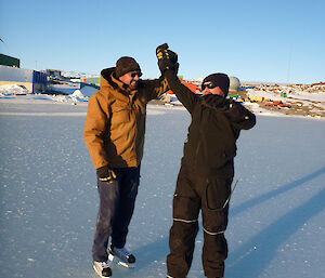 Two skaters attempting a dance move