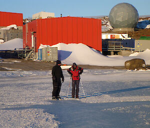Two Skaters one with ski poles on the harbour sea-ice