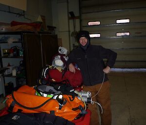A quad bike prepared for sea-ice travel with a koala named Bear Grylls on the bike and an expedioner standing beside the vehicle