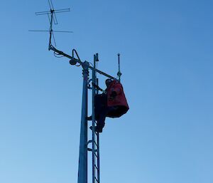 An expeditioner high on a Tower tidying up some loose parts
