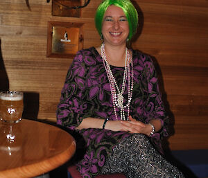Female expeditioner wearing pearls and with green hair
