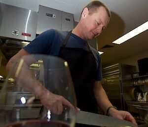 An expeditioner cutting potatoes for hi potato bake dish