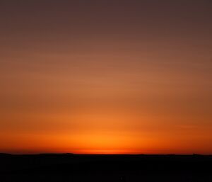 The northern sky was a deep orange yellow although the sun did not rise above the horizon on the day