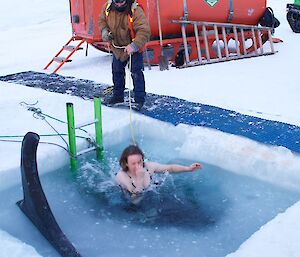 Female expeditoner in the water with ice on the surface