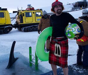 A Scootish expeditioner wearing an artifical kilt and beret in preparation for the swim