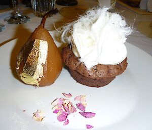 Poached pear with gold leaf and chocolate cake with sugar floss