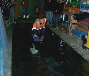 Male expeditioner trying his luck at curling