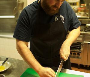 An expeditioner cutting carrots lengthwise