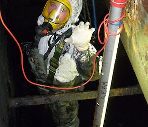 An expeditioner protective suit, harness and wearing breathing apparatus in the Waste Treatment Plant after removing the last of the sludge