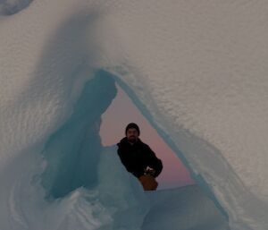 A person behind a pile of sea ice