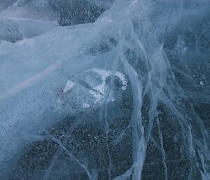 Surface of lake ice showing cracks and bubbles