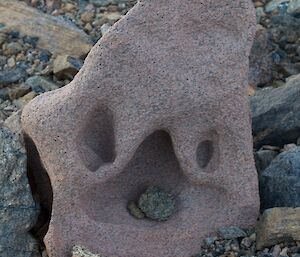 Rock with pebbles in sculpted curves