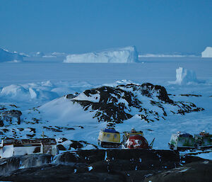 Looking down on the hut and ‘apple’ shelter on Macey Island with sea-ice and icebergs in the distance