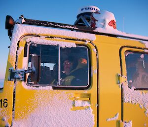 Two expeditioners in the yellow Hägglunds