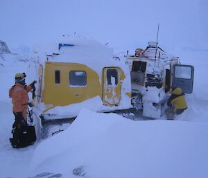 Oversnow vehicle with snow covering the roof and sides