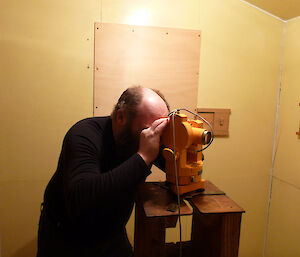 An expeditioner focussing the theodolite in the Absolute Hut