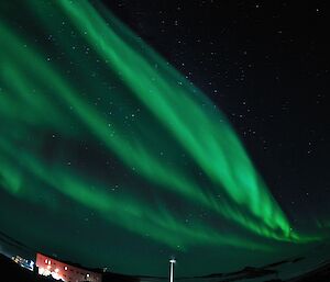 An Aurora Australis with curtains of green in the sky