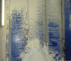 A shot inside the Balloon Shed with snow building up on the floor after leaking through the door seals