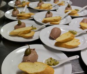 Several plates beautifully presented with food waiting to be served