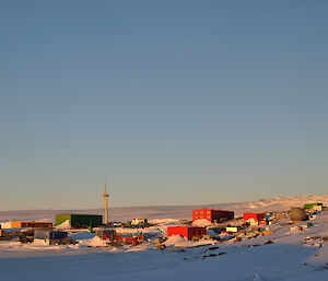 A view of Mawson with the various buildings and one of the wind turbines