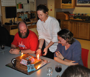 The Chef presents the mud cake to the two expeditioners who were celebrating their birthdays whilst another expeditioner looks on