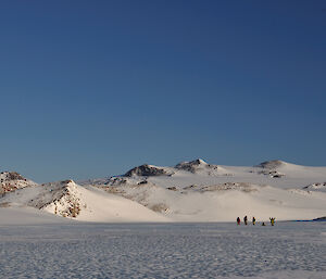 Several expeditioners standing on the frozen waters of Lake Reynolds