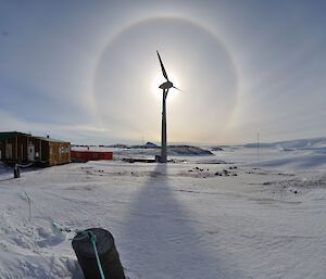 A halo around the sun in August with the wind turbine lined up to give maximum effect