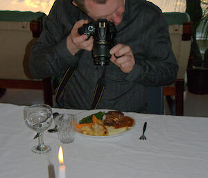 Person pointing camera at dinner plate