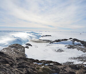The Taylor Glacier emperor penguin colony is in the middle distance with the glacier to the left of the photo and the amphitheatre or rock ridges surrounding the deep snow on which the penguins are breeding