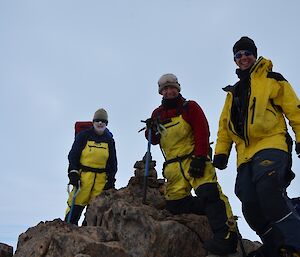 Three expeditioners standing on one of the high peaks on the ridge