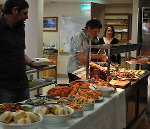 Expeditioners helping themselves to the buffet