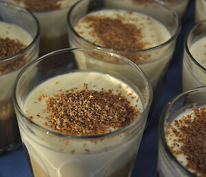 A glass with layered Pannacotta (vanilla, coffee and chocolate)