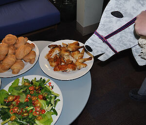 Plates of chicken, fresh bread rolls and hydroponically grown salad and a wooden horse’s head to signify a Chicken and Champagne breafast whilst watching the Melbourne Cup