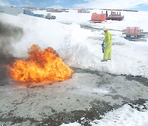 An expeditioner discharging a foam extinguisher