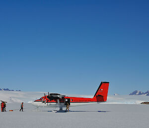 The Twin Otter tethered to an ice spike drilled into the ice