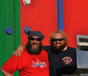 The cook and his helper with thebarbecue in front and the multi coloured panelled Rosella Building