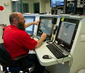 A Communications operator at the console communicating with the pilots