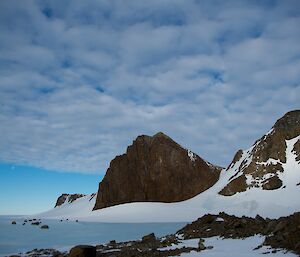 A mountain in teh shape of a sharks fin as seen from the front window at Rumdoodle field hut