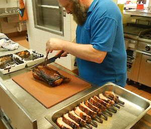 Expeditioners slicing his pork dish