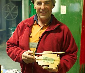 Expeditioner holding his birthday present made by Wayne on station